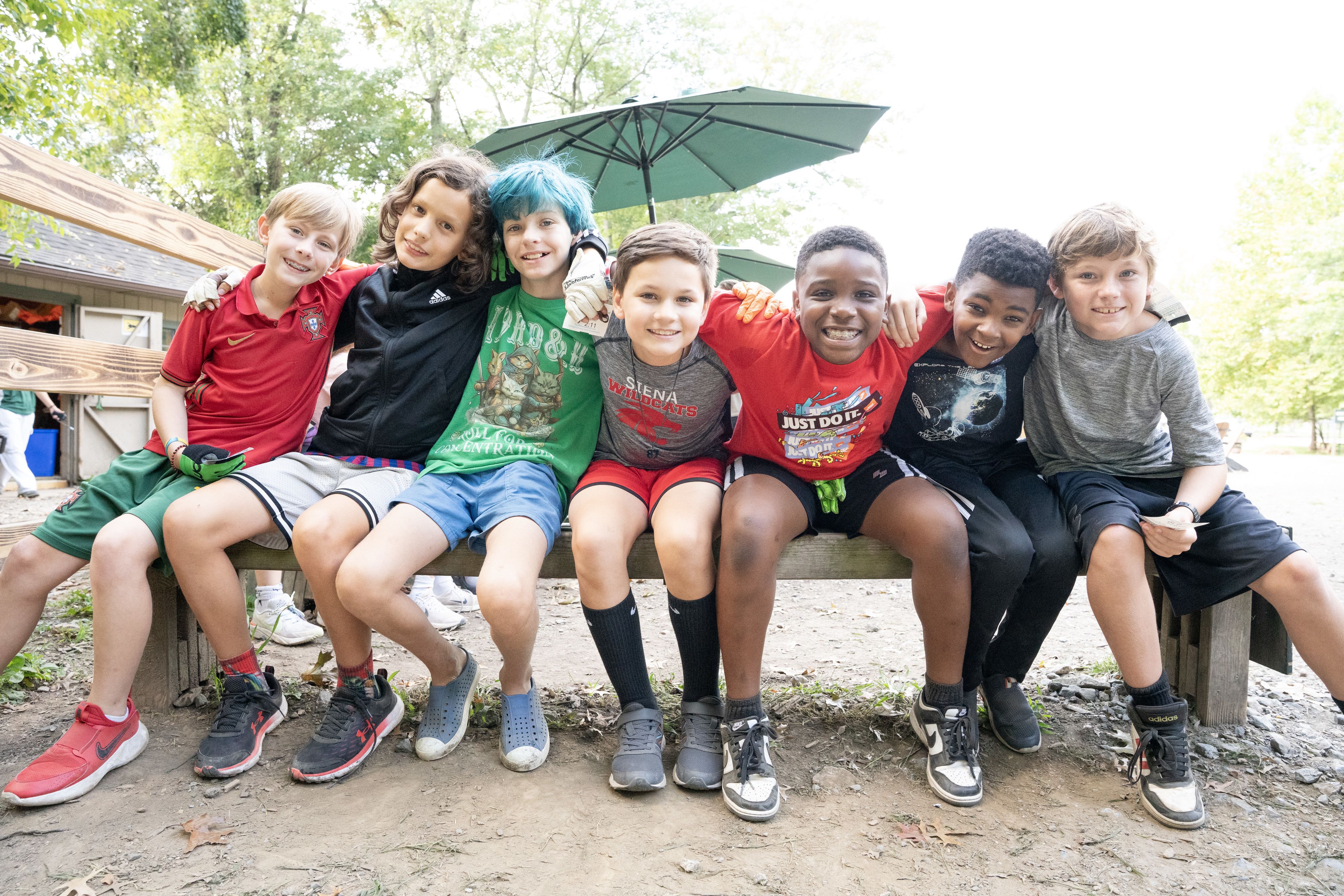 High school student high-fives teachers on the first day of school.